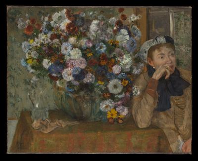 Woman beside a vase of flowers